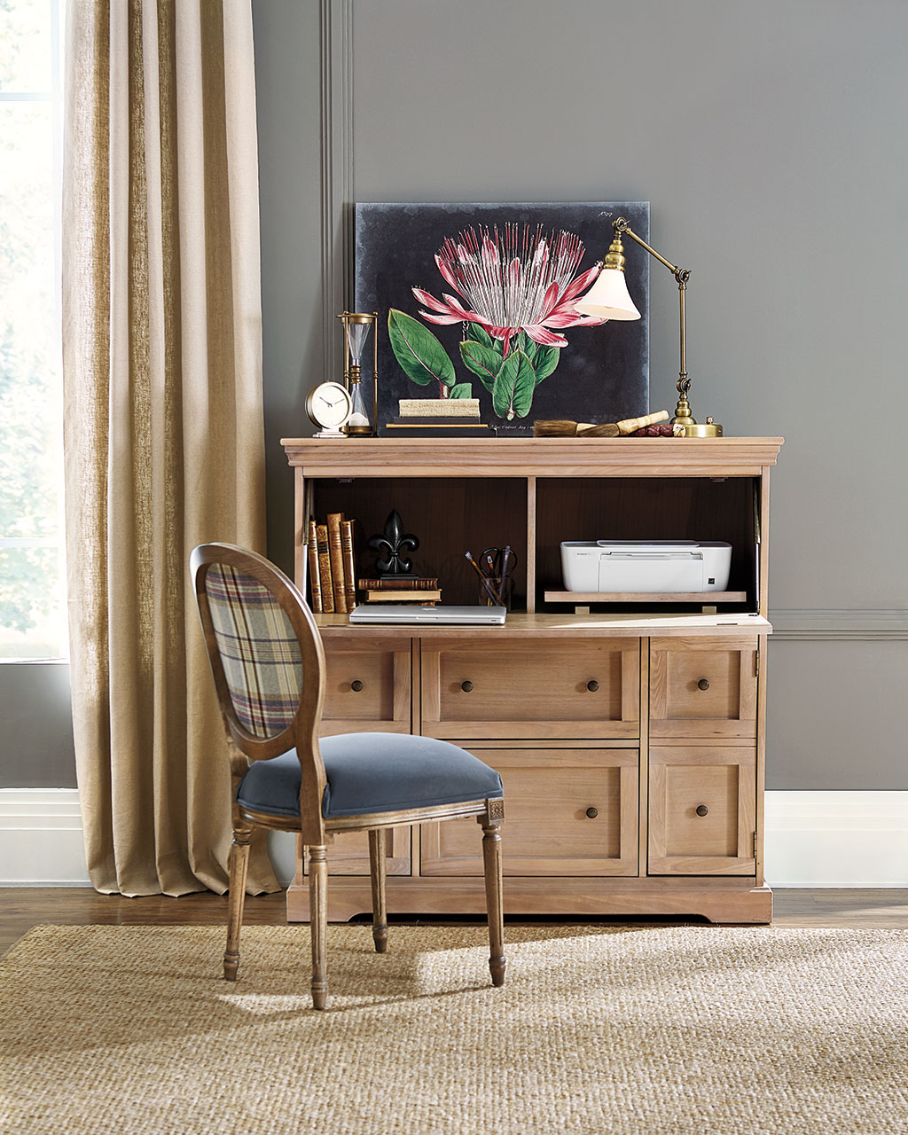 Carve out a new room with a large secretary desk and pull up an upholstered chair