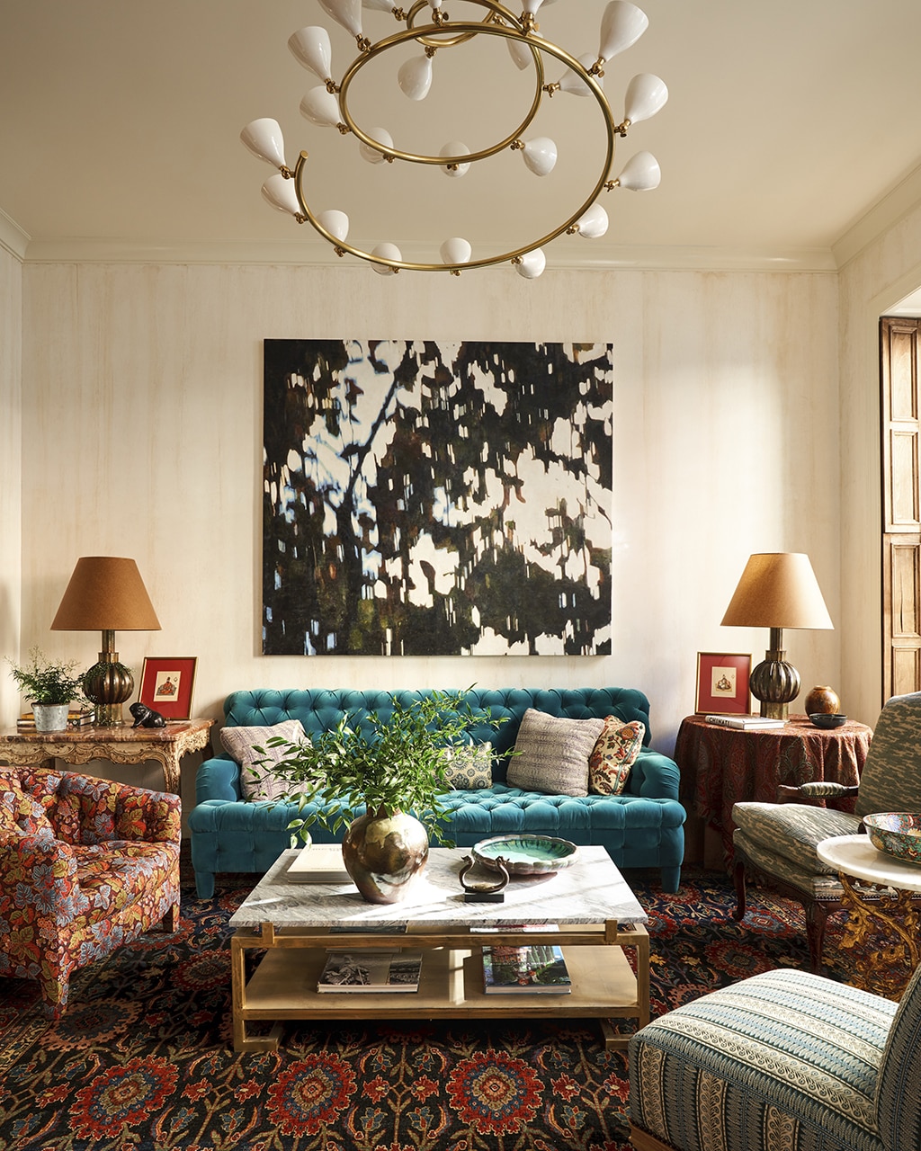 Living room decorated by Markham Roberts with teal velvet sofa