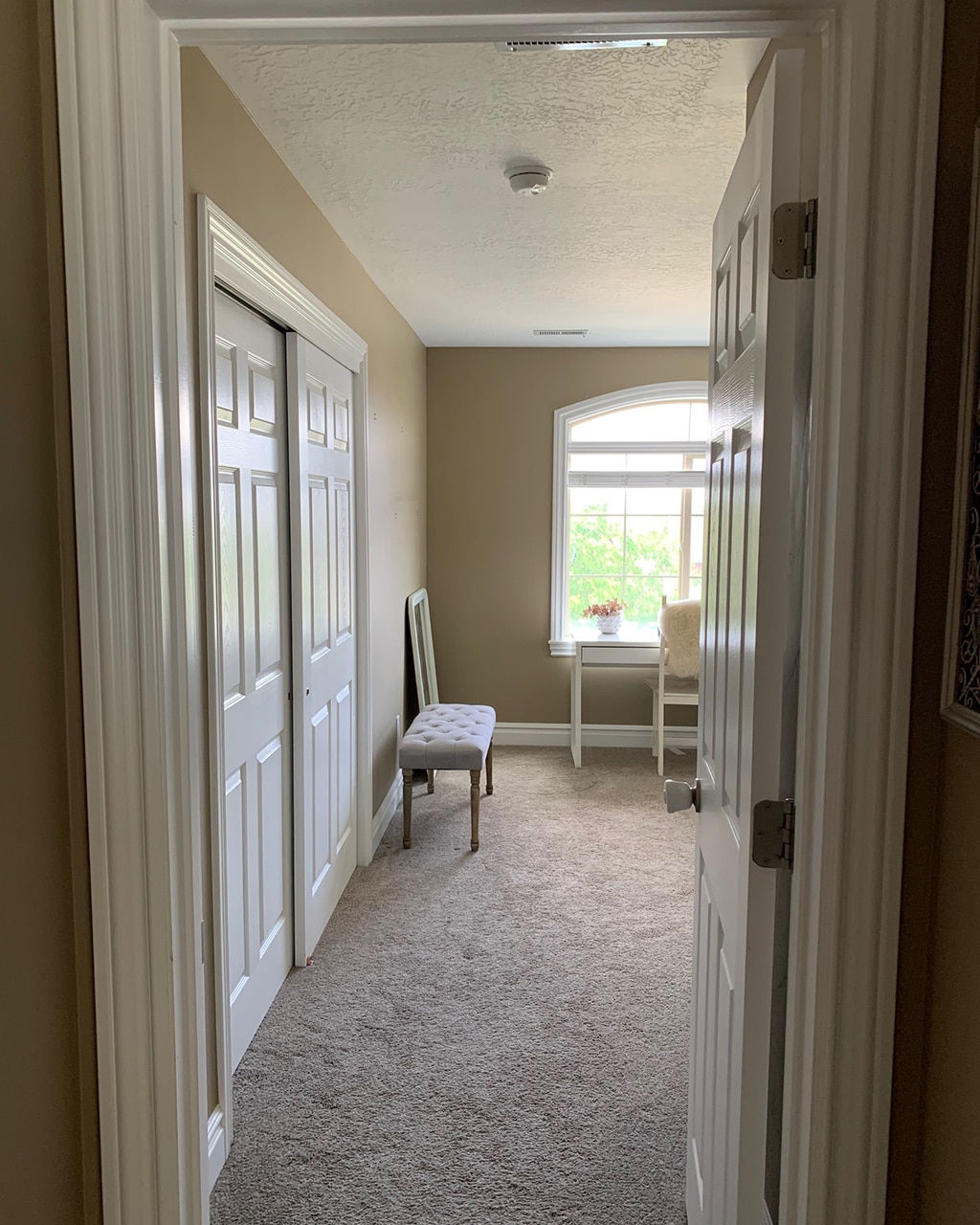 Chloe's large room with carpet and tan walls