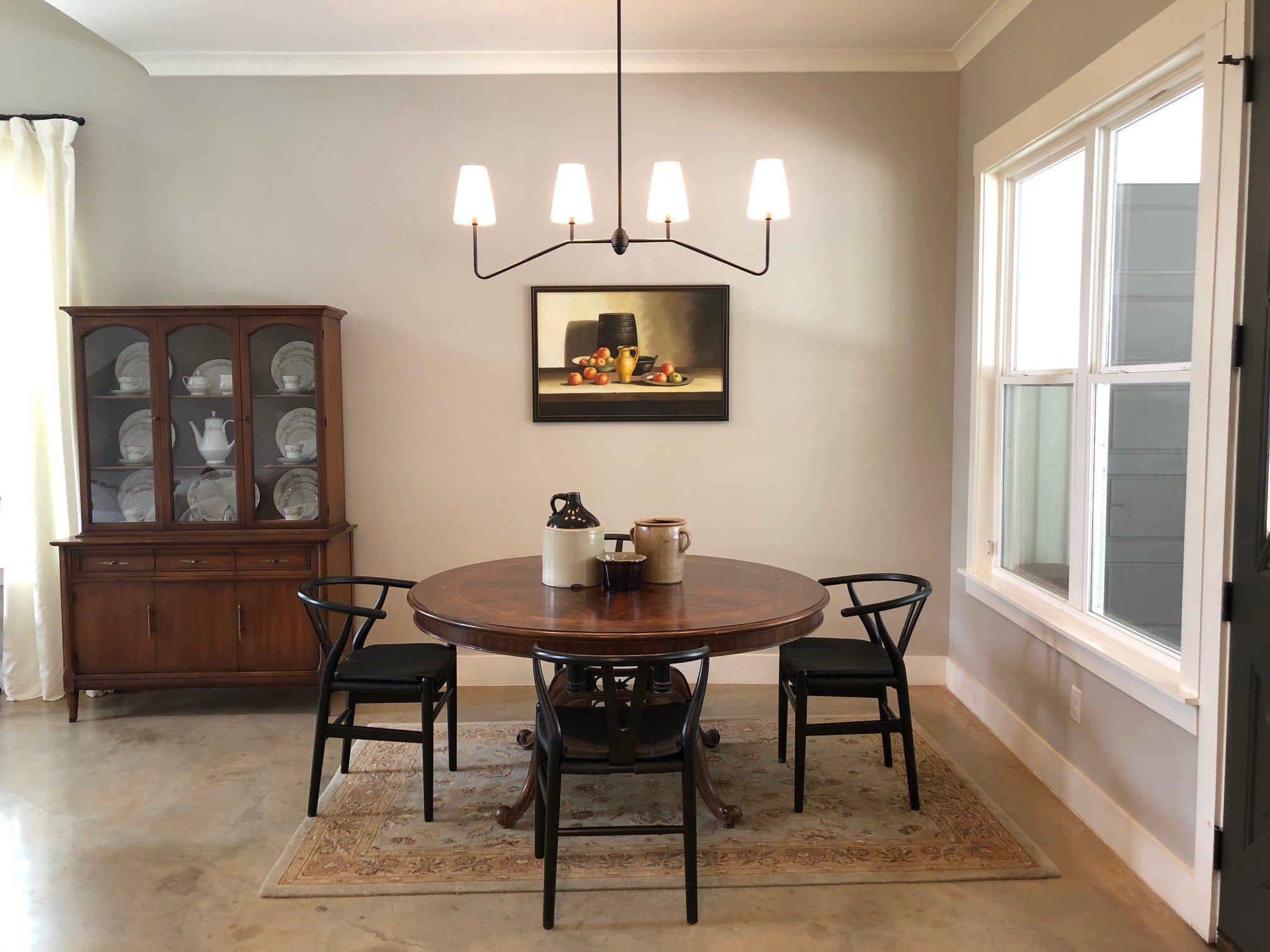 Antique table and hutch with modern wishbone chairs