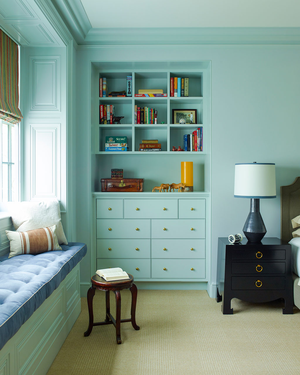 Aqua bedroom with built in bookcases and window seat, designed by Peter Pennoyer and Alice Engel