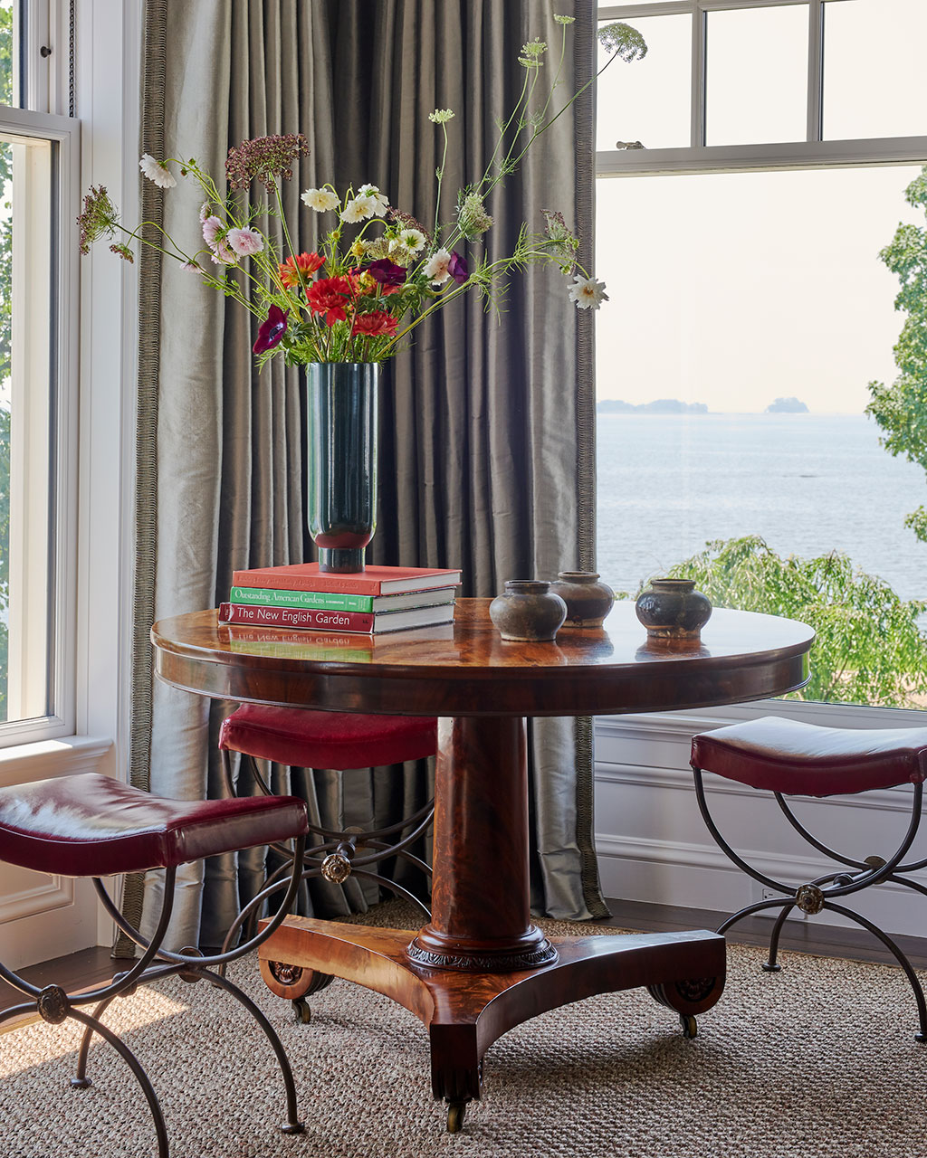 Antique round table in window, designed by Matthew Patrick Smyth