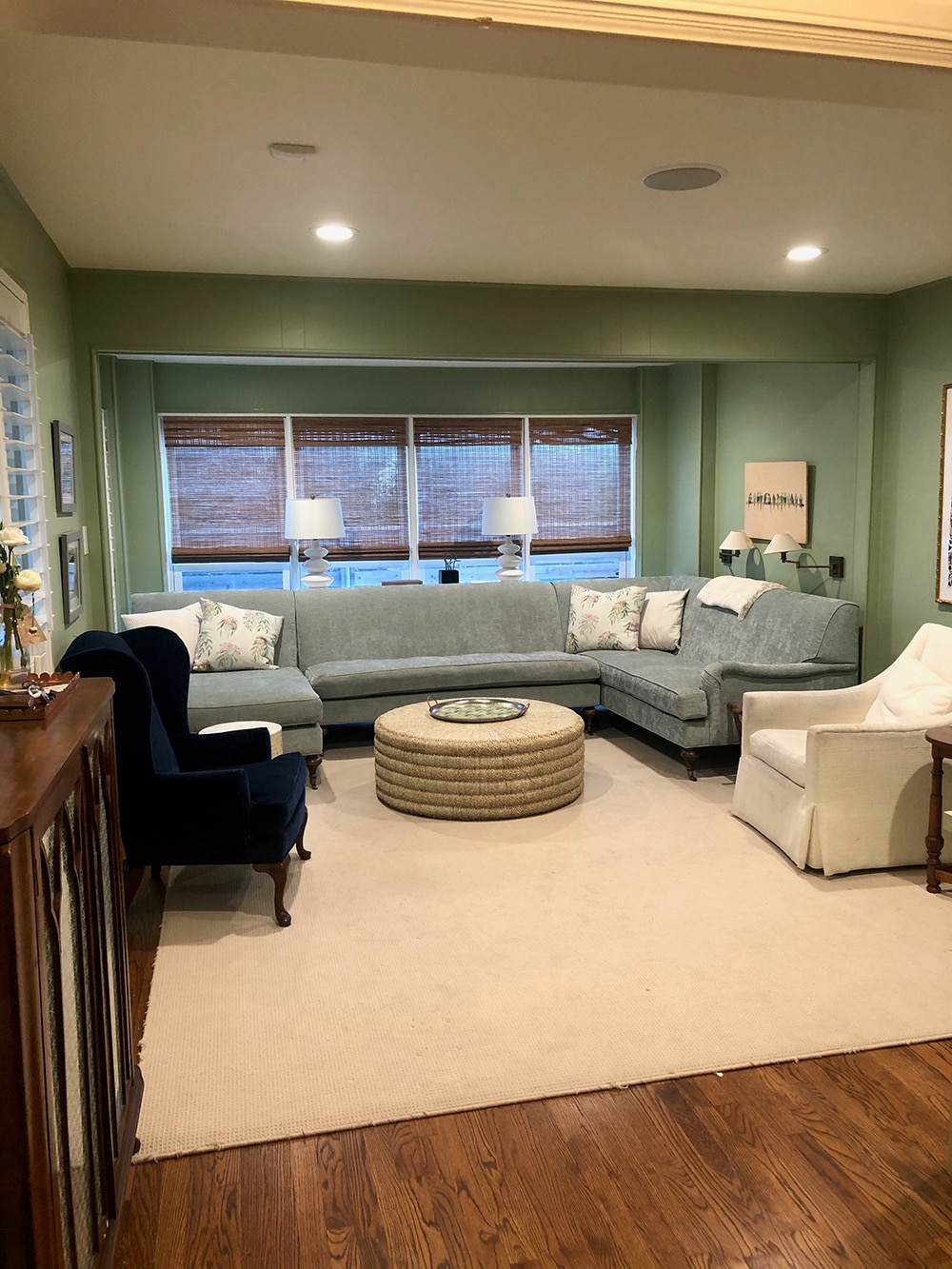 Malorie's family room with a custom sectional and green wall color