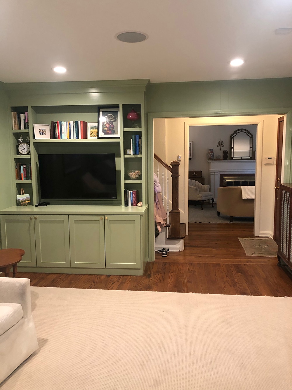 Malorie's green family room with built in media cabinet