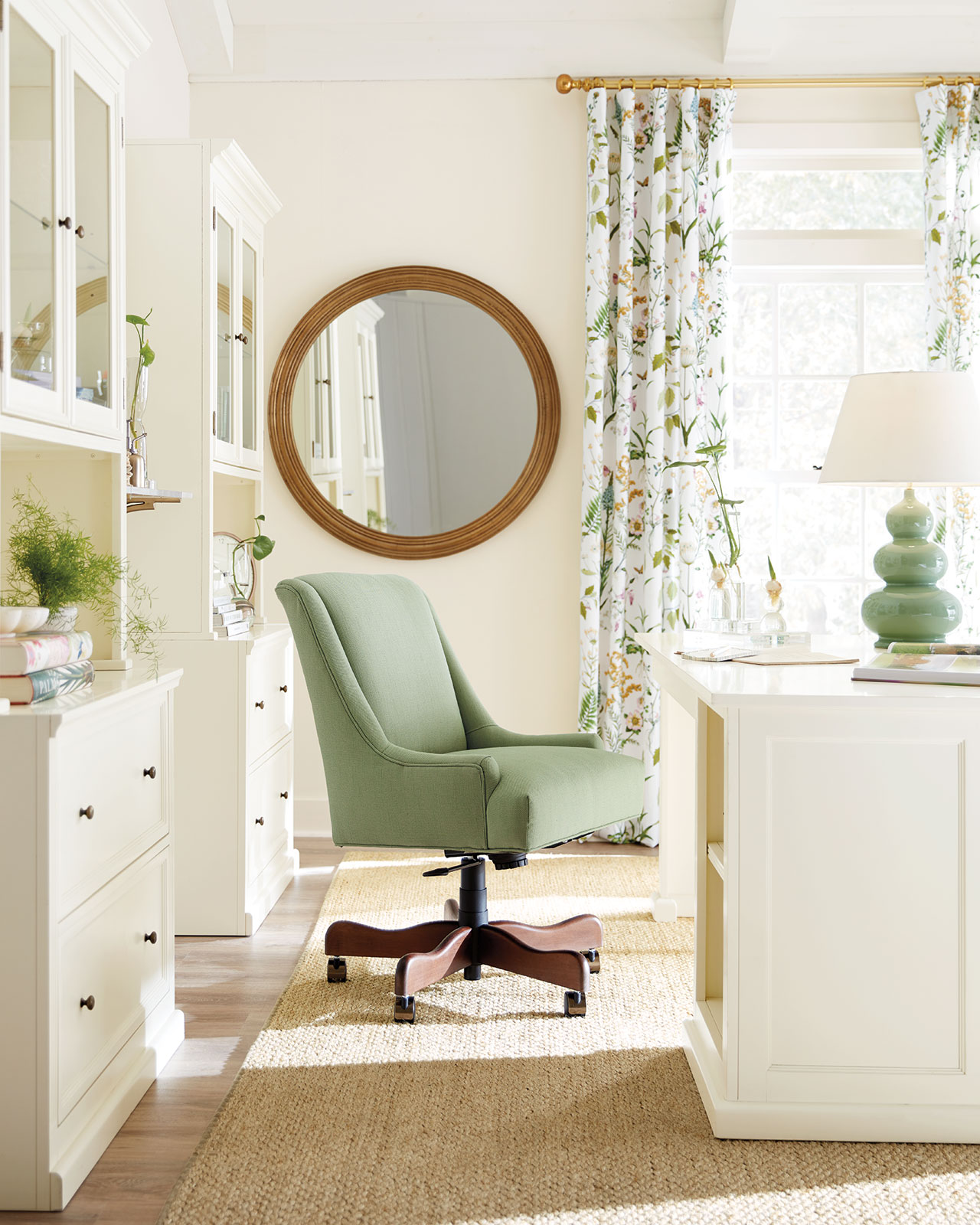 Home office with green office chair and patterned curtains