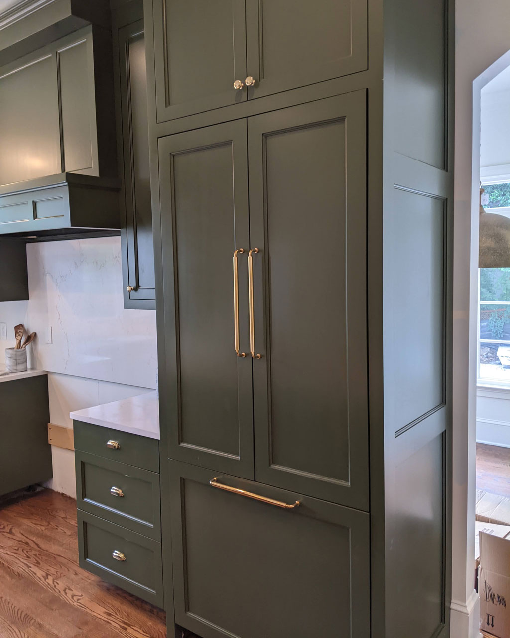 Green cabinets and brass hardware in Taryn's kitchen