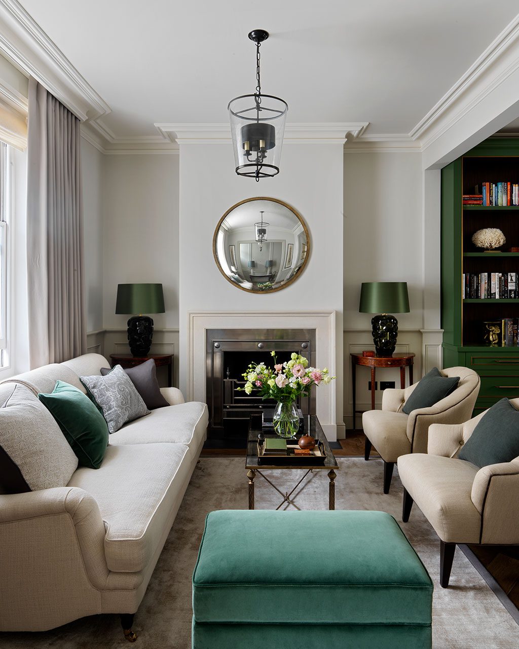 Traditional neutral living room with green velvet accents, designed by Emma Sims-Hildith