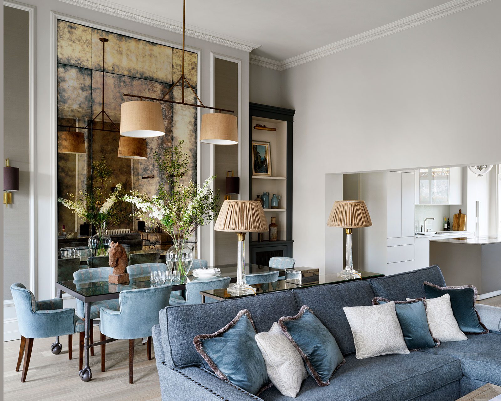 Living and dining room with dusty blue accents in velvet, designed by Emma Sims-Hilditch and featured in her new book