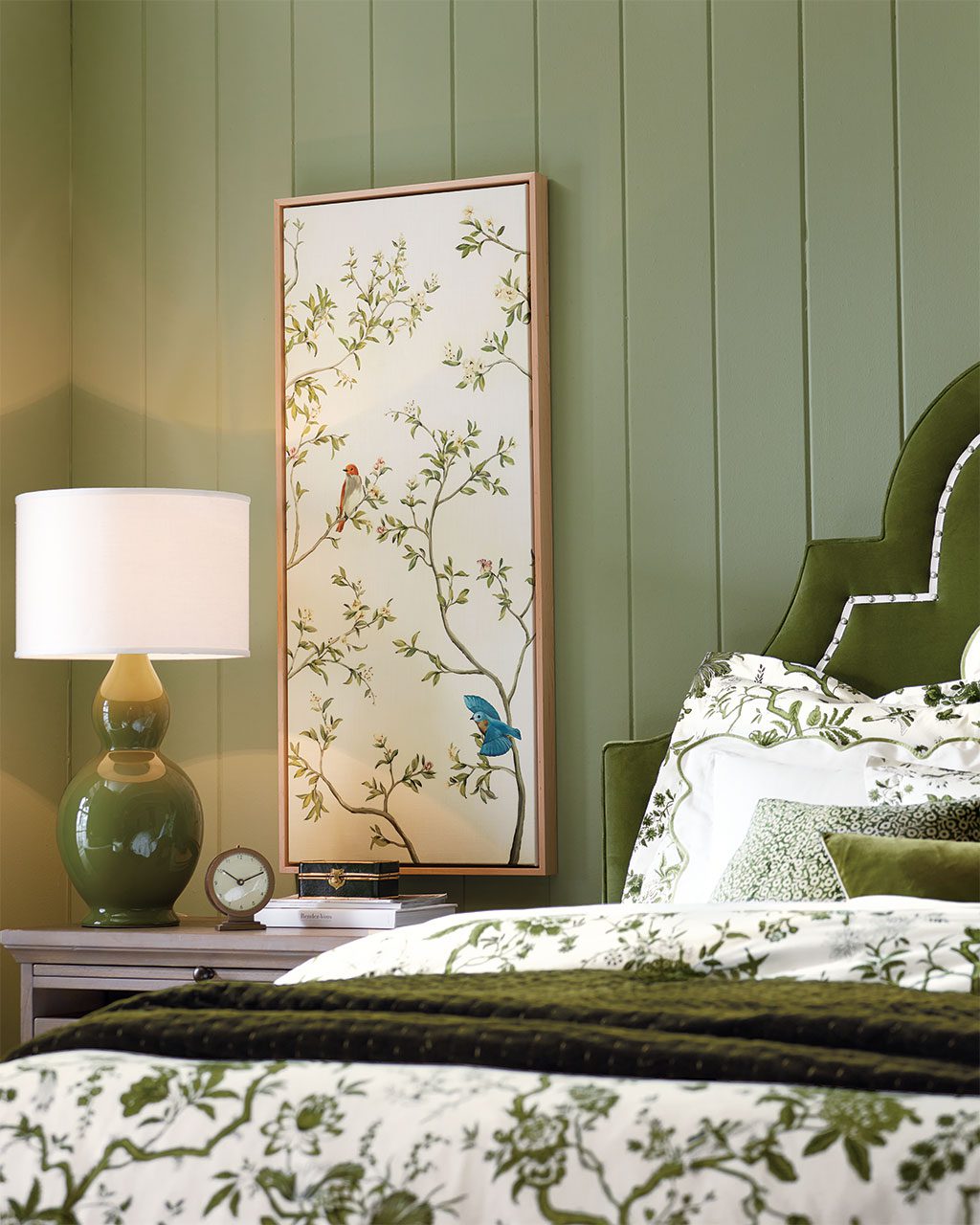 Table lamp on bedside table in green bedroom from Ballard Designs