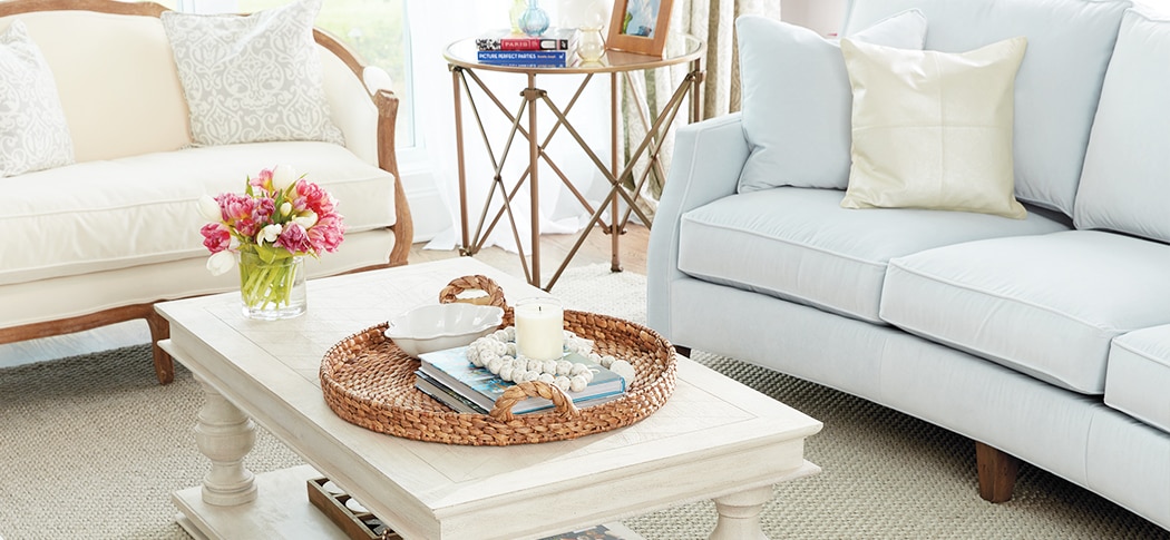 Blue velvet couch with rounded back in blue and white living room